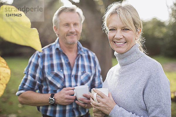 Portrait lächelndes  glückliches reifes Paar beim Kaffeetrinken im Hinterhof