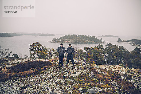 Sweden  Sodermanland  two men standing at archipelago landscape