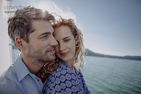 Happy couple on a sailing boat