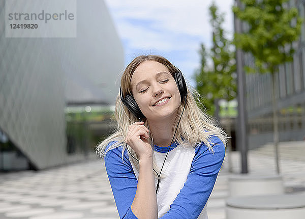Young blond woman with earphones