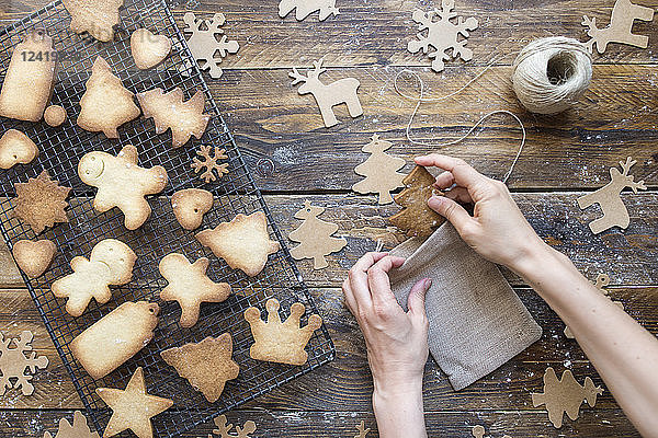 Woman's hands packing homemade Christmas cookies into sachet