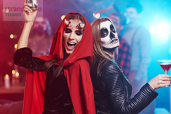 Women in creepy costumes dancing at Halloween party