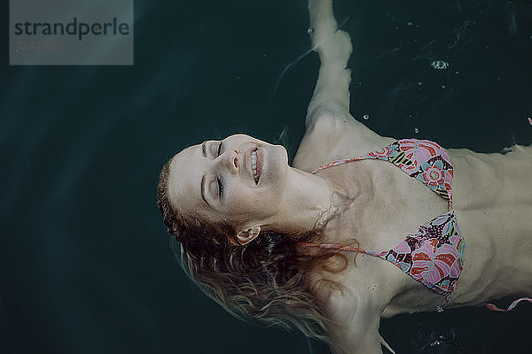 Carefree woman swimming in water