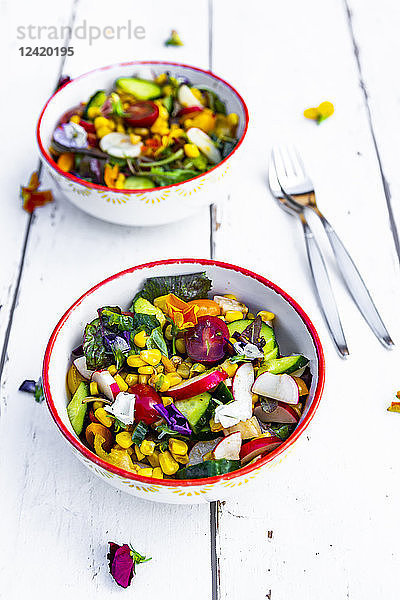 Bowls of mixed salad with edible flowers
