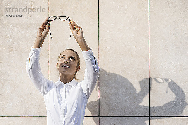 Young businesswoman looking up through her glasses