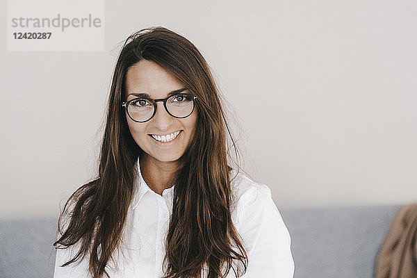 Portrait of a pretty  clever  young woman  wearing glasses