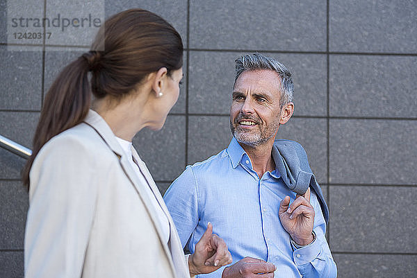 Portrait of smiling businessman listening to his business partner