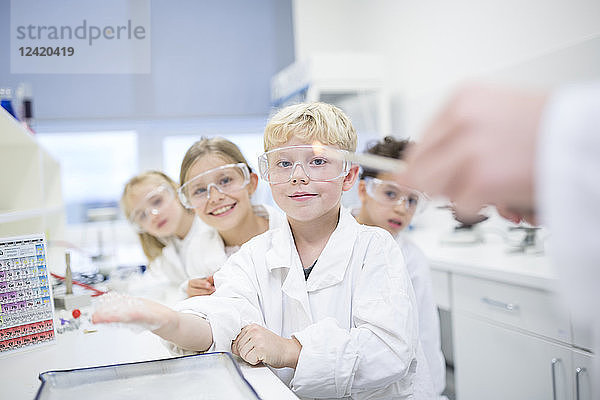 Portrait of smiling pupils in science class