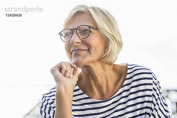 Portrait of smiling senior woman outdoors