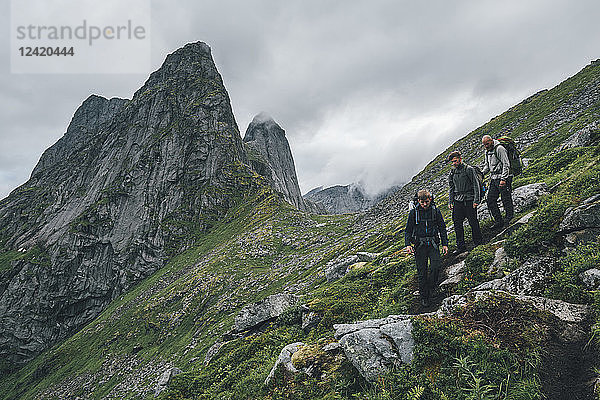 Norway  Lofoten  Moskenesoy  Young men hiking at Markan mountain