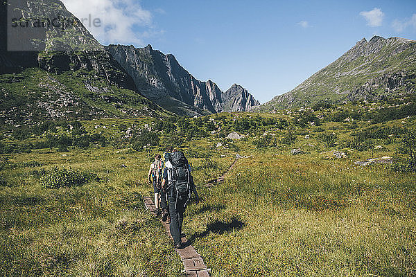 Norway  Lofoten  Moskenesoy  Young men hiking at Litljordtinden