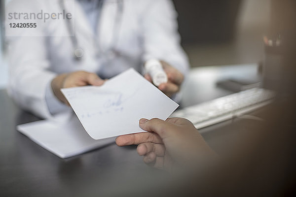 Doctor giving patient a note