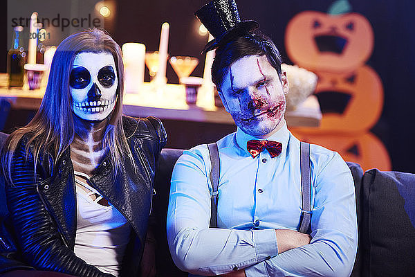 Portrait of spooky couple at Halloween party