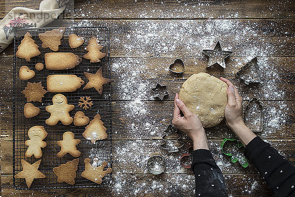 Woman's hands kneading dough for gingerbread cookies