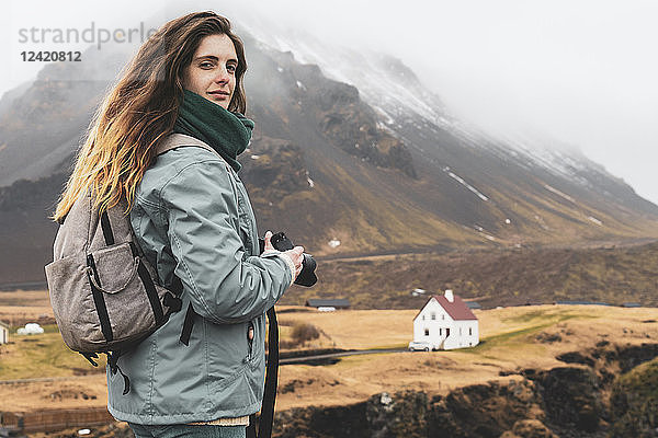 Iceland  portrait of hiker with backpack and camera