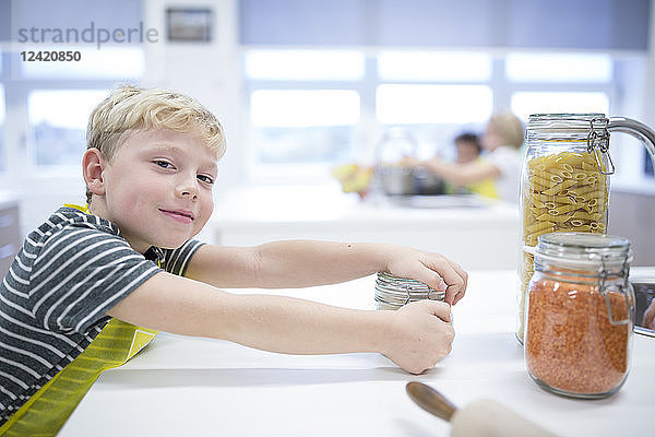 Portrait of smiling schoolboy in cooking class