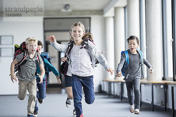 Excited pupils rushing down school corridor