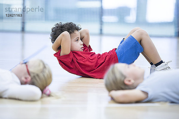 Pupils exercising in gym class