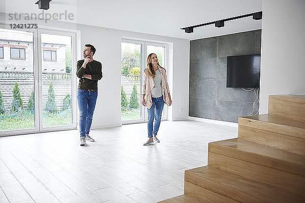 Couple looking around in empty flat