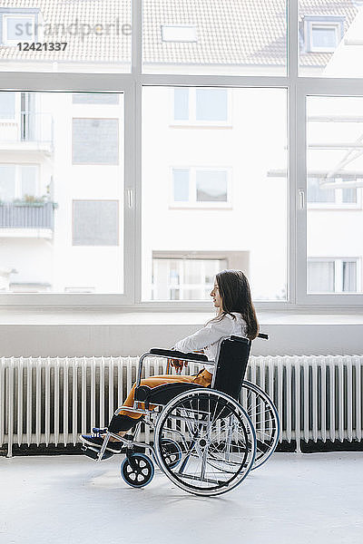 Young handicapped woman sitting in wheelchair