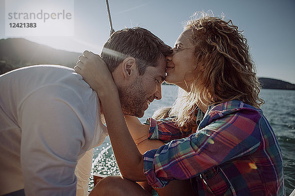 Affectionate couple with son on a sailing boat