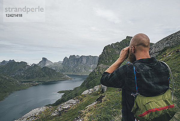 Norway  Lofoten  Moskenesoy  Man looking over Kjerkefjord