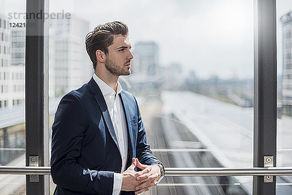 Businessman at the window looking around