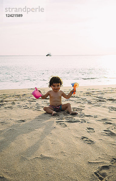Baby girl playing on the beach