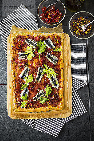 Pizza Marinara garnished with anchovies and parsley