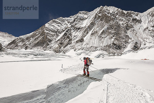 Nepal  Solo Khumbu  Everest  Sagamartha National Park  Mountaineer crossing icefall on a ladder