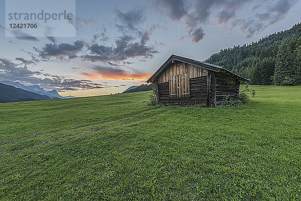 Germany  Bavaria  Werdenfelser Land  hay barn at sunrise