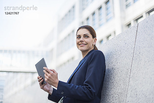 Portrait of smiling businesswoman with tablet
