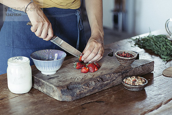 Woman preparing cutting strawberries on cutting board