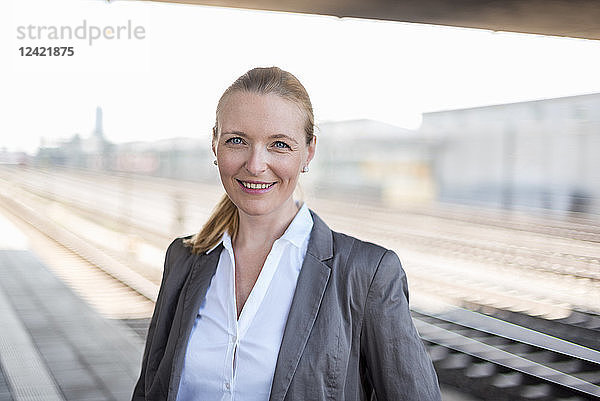 Portrait of smiling businesswoman at platform