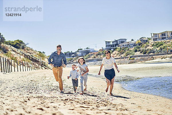 Australia  Adelaide  Onkaparinga River  happy family running on the beach together