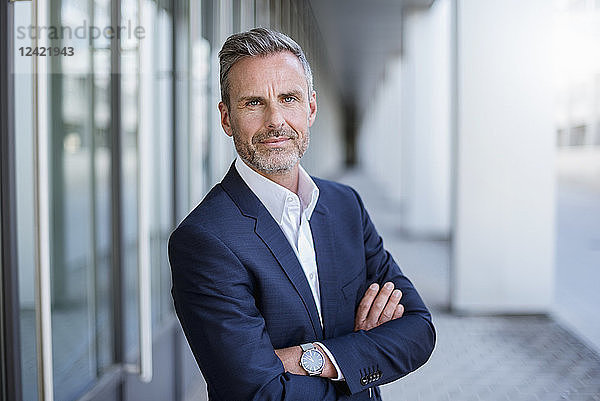 Portrait of businessman wearing blue suit coat and wrist watch