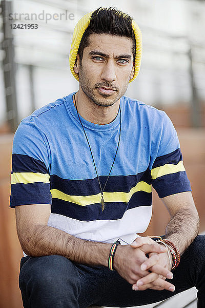 Portrait of fashionable young man wearing cap an striped t-shirt