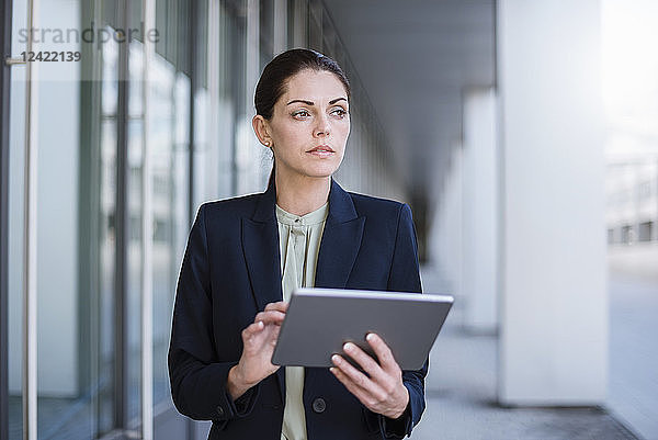 Portrait of serious businesswoman with tablet