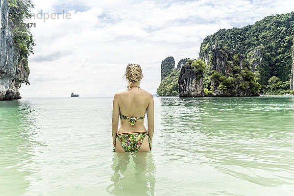 Thailand  Ko Hong  back view of woman standing in the sea looking to horizon