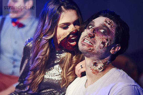 Creepy woman trying to bite her boyfriend at Halloween party