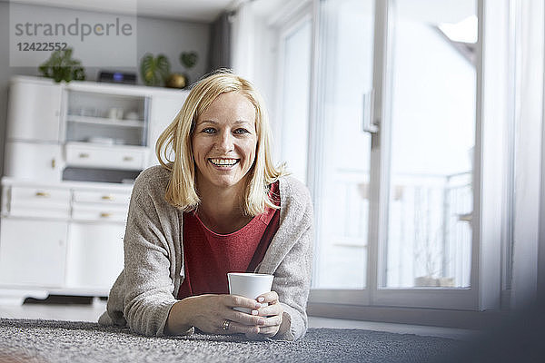 Happy woman relaxing at home  drinking coffee