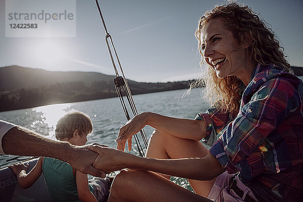 Happy family on a sailing boat