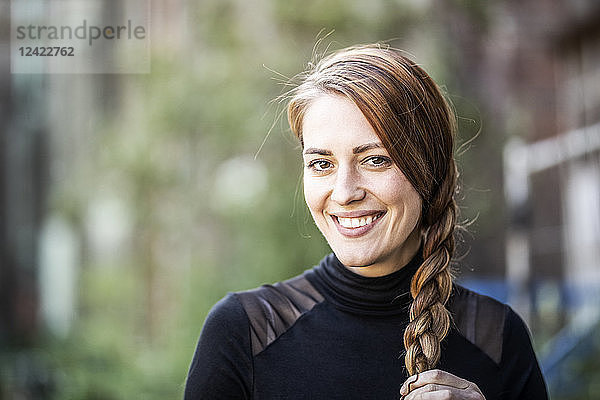 Portrait of smiling woman with braid