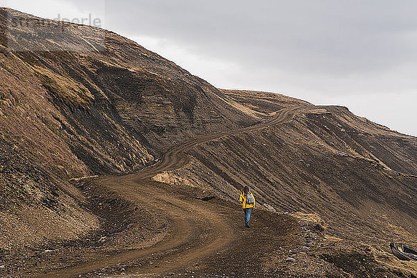 Iceland  woman walking in deserted landscape