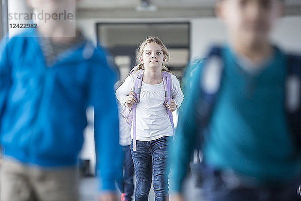 Schoolgirl with classmates leaving school