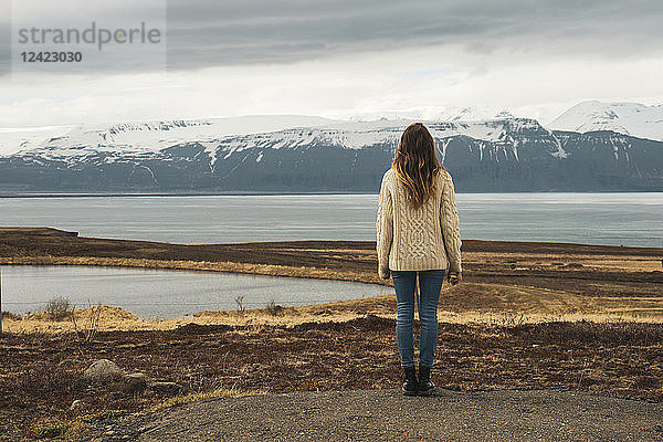 Iceland  woman standing at lakeside