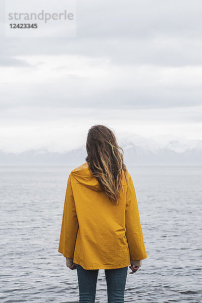 Iceland  woman standing at the sea