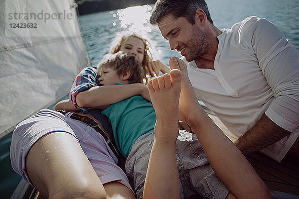 Happy family relaxing on a sailing boat