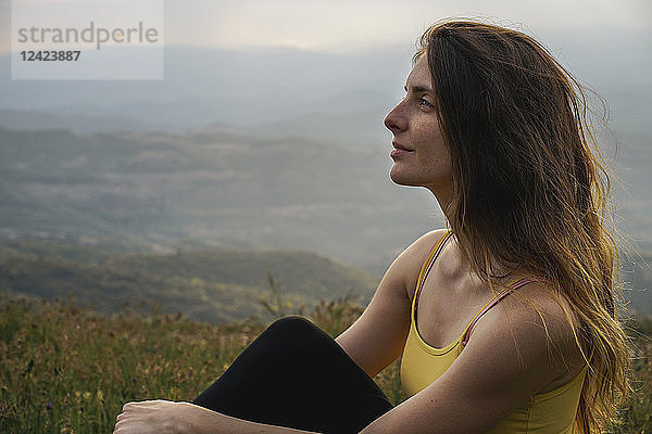 Spain  Barcelona  portrait of young woman relaxing on Montcau Mountain