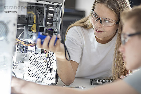 Students assembling computer in class
